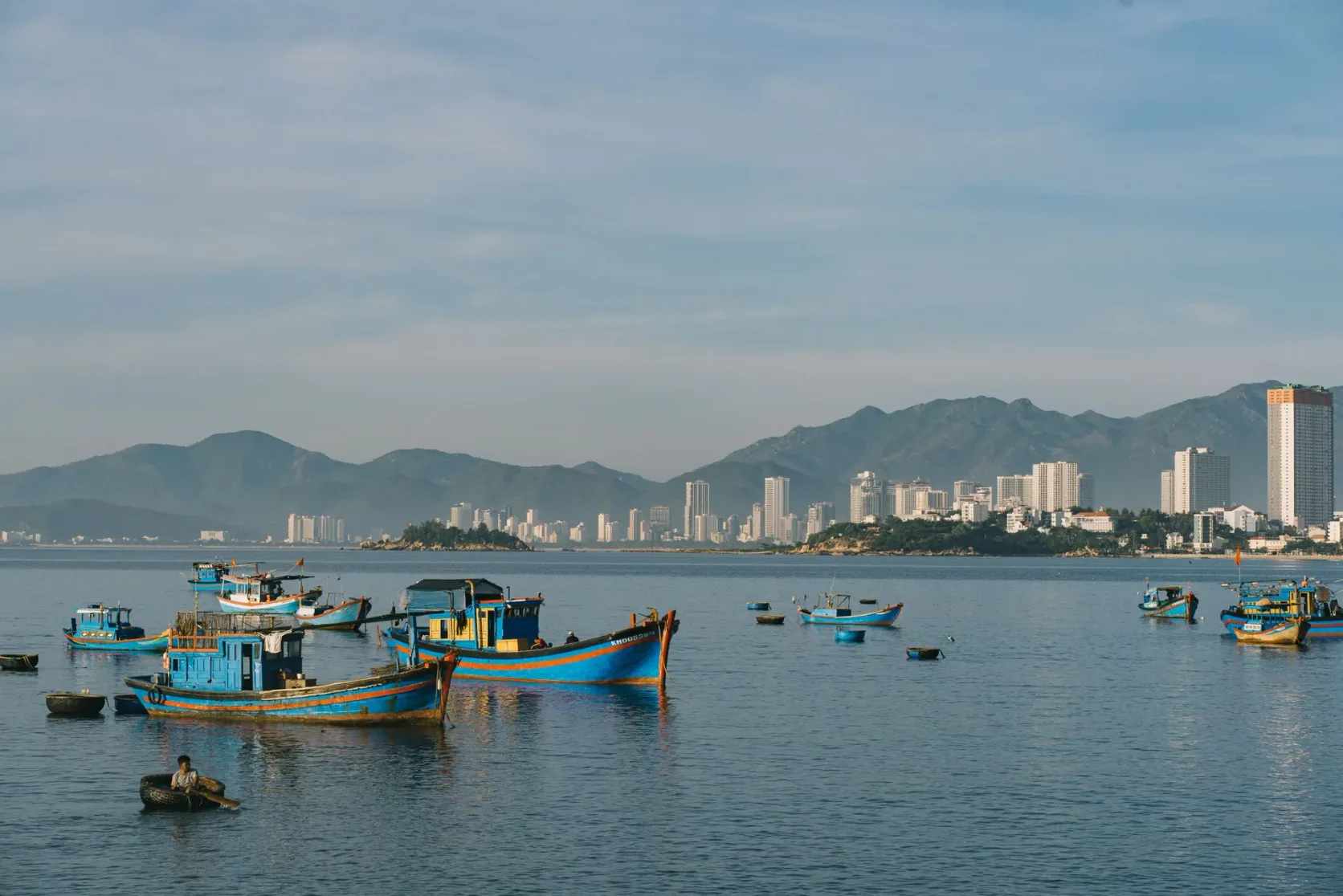 Fishing boats moored in the bay at Nha Trang, the city behind.